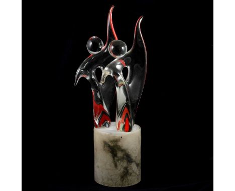 A Murano glass sculpture by Alfredo Rossi, circa 1970s, modelled as two figures with swirls of red, mounted on a hollow base,