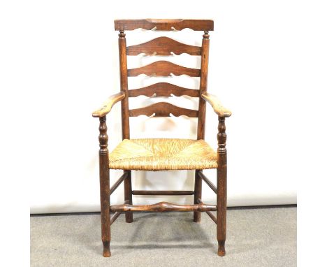 Victorian elm and ash ladder back elbow chair, rush seat, turned legs and rails, width 62cm, height 105cm.