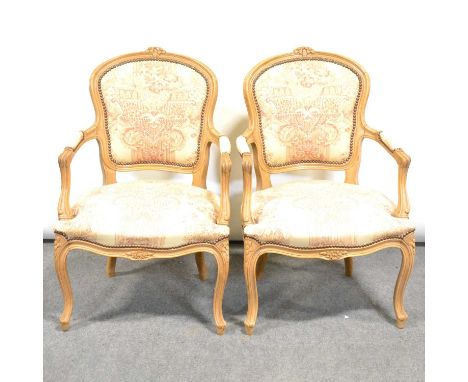Pair of Louis XV inspired beechwood armchairs, moulded and carved outlines, cotton print upholstery, width 57cm, height 84cm.