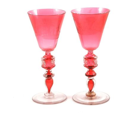 Pair of large Continental ruby and engraved glass goblets, probably Bohemian, the conical bowls wheel engraved with hunting s