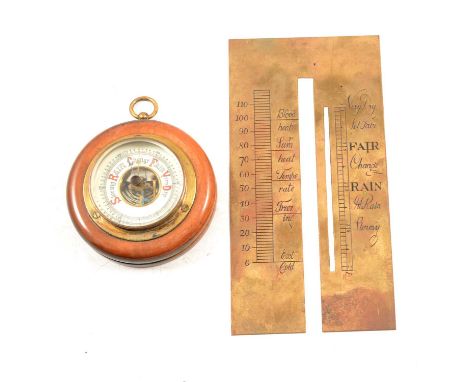 Small wood and brass circular wall barometer, Gothic enamelled lettering, 8.5cm diam, and a brass barometer scale plate.Qty: 