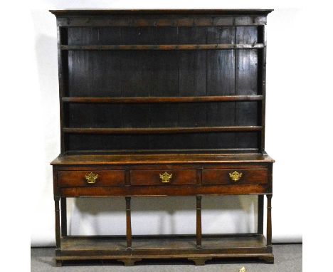 George III oak dresser, three shelf delft rack under a moulded cornice, the base with three freize drawers, pot-board base, w