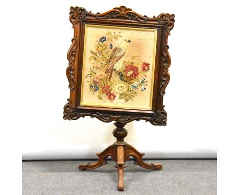 Victorian walnut pole screen, with gros point needlework panel of a parrot and flowers, moulded and scrolled frame, on a trip