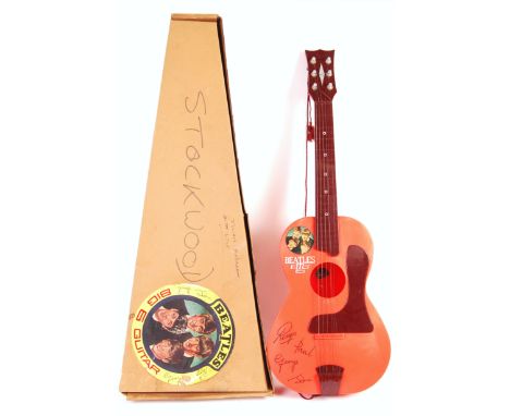 A rare vintage 1960's (1964) Selcol made The Beatles ' Big 6 ' plastic acoustic model guitar. Burgundy, red and orange plasti