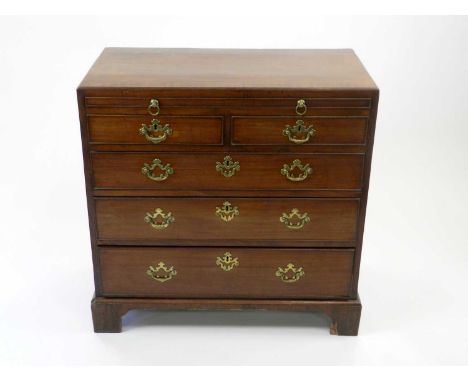 A George III mahogany chest of drawers, the crossbanded top above a brushing slide and two short over three long graduated an