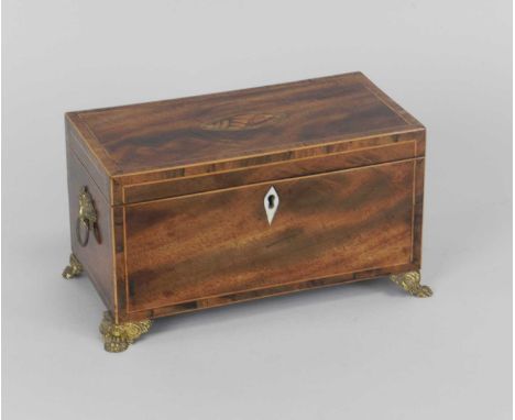 A George III inlaid mahogany tea caddy, the top inlaid with a conch shell, raised on gilt metal claw feet, 23cm wide.