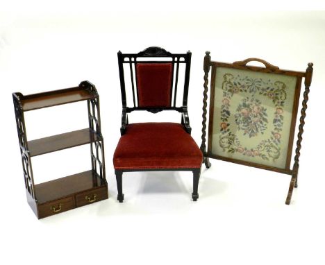 An ebonised upholstered nursery chair with red velvet fabric, an Edwardian mahogany mural shelf with openwork sides and two d