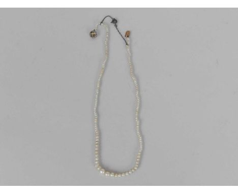 An untested graduated pearl necklace, with seed pearl and stone set clasp, 39cm long