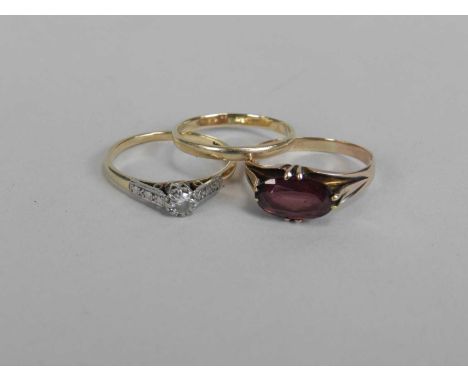 A single stone diamond ring, stamped '9ct plat', size M 1/2, together with a single stone garnet ring, size N and a 9ct gold 