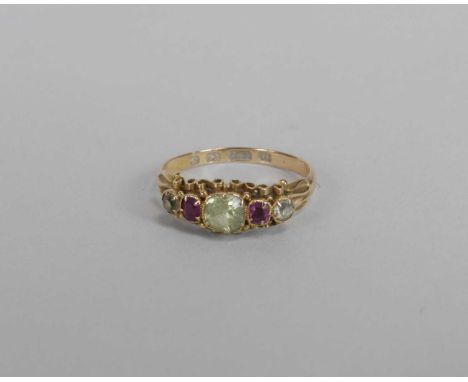 A Victorian 15ct gold chrysoberyl and ruby ring, designed as a central chrysoberyl flanked to each side by a ruby and further