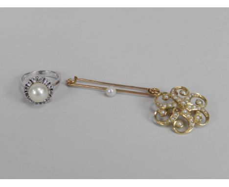 A split seed pearl brooch/pendant, stamped to the reverse '15ct', (lacking one seed pearl), together with a single seed pearl