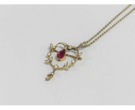 An early 20th century synthetic ruby and seed pearl pendant/brooch, designed as a central pear shaped synthetic ruby drop sus