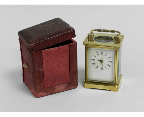 A brass cased carriage clock, first quarter 20th Century, with leather carry case and key (at fault).