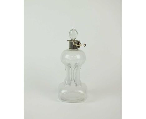 A silver mounted lockable decanter, John Grinsell &amp; Sons, Birmingham 1921, the clear glass body with faceted stopper, 28.