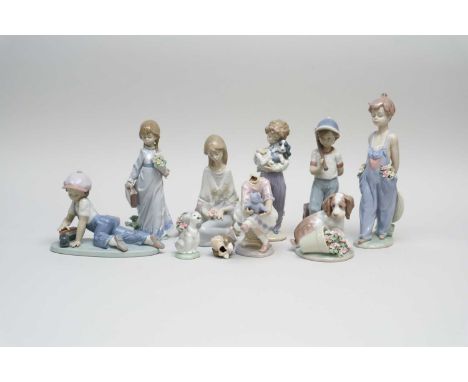 Nine Lladro porcelain figures late 20th century including a boy with a baseball bat, a boy with a train, a boy wearing dungar