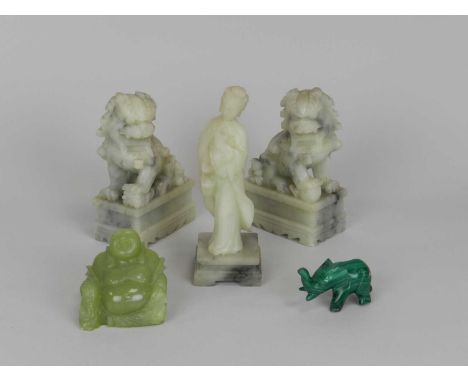 An assembled group of Chinese hardstone figures, 20th Century, including a pair of pale green soapstone lion dogs, 15cm high,
