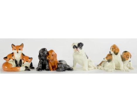THREE ROYAL WORCESTER GROUPS OF THREE PUPPIES OR FOX CUBS AND A SIMILAR ROYAL WORCESTER MODEL OF A DOG, 6CM H AND CIRCA, BLAC