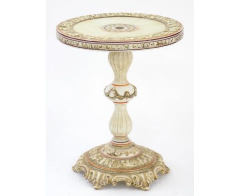 A CAPO DI MONTE CREAM AND BROWN CERAMIC TABLE DECORATED WITH A CHERUB BORDER, 54CM DIAM AND 69CM H