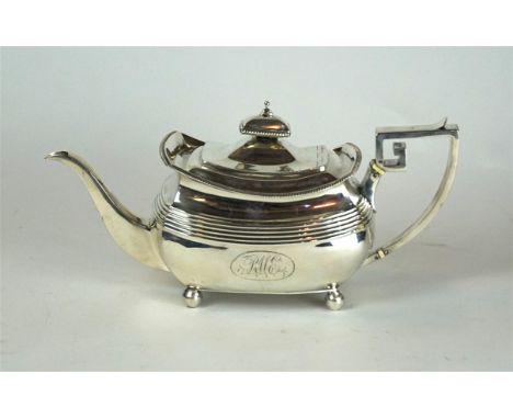 A George III hallmarked silver teapot
Of square form, having a cast rim above engraved initials RME, raised on four ball feet