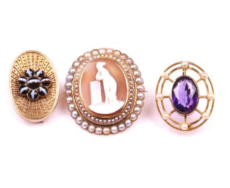 Three late 19th/early 20th Century brooches
To include a cameo brooch, the central oval shell cameo within a double border of