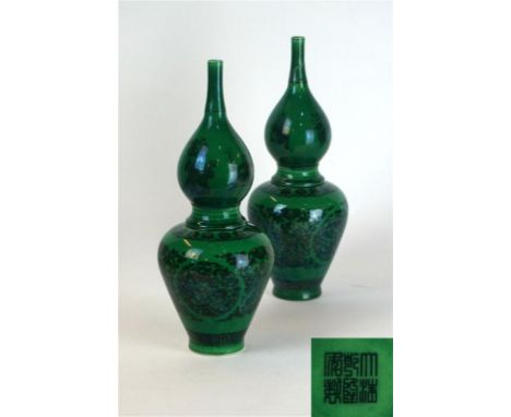 A pair of Chinese green-glazed double gourd vases, Qianlong seal mark, 20th Century
Each of the slender vases, typically mode