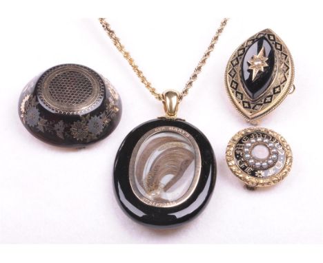 A collection of Victorian mourning jewellery
To include a brooch of circular form with central window revealing hairwork with