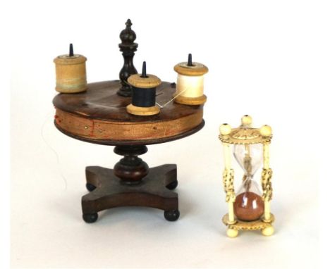 A Victorian rosewood novelty sewing accessory
In the form of a miniature dining table fitted with a central turned finial car