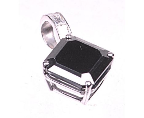 An impressive black diamond single stone pendant
The square step cut black diamond of an estimated 6ct, four claw set to a wh