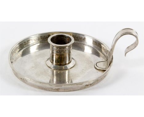 An Arts & Crafts hallmarked silver chamber stick 
Of circular form, the central candle holder having linear design in a band,