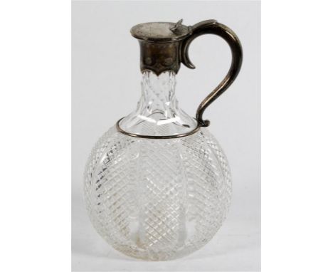 A Victorian hallmarked silver mounted cut glass claret jug
Of ovoid form, having engraved family motto of a figure to cover, 