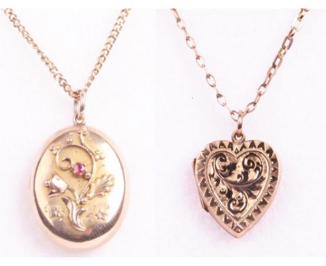 Two early 20th Century lockets
The first having applied floral decoration and set with a small round cut garnet topped double
