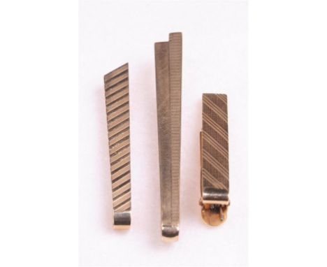 Three gold tie clips
Two hallmarked 9ct gold, one stamped 14k, with varied engine turned decoration, gross weight 17gms.