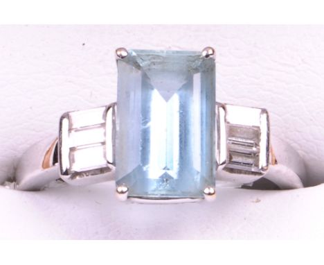 An 18ct white gold, aquamarine and diamond set dress ring
The rectangular step cut aquamarine of approx 10x7mm, four claw set