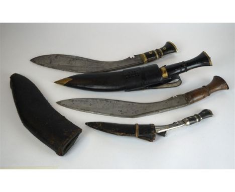 A Nepalese kukri knife, late 19th/early 20th Century
The 32cm single edged curved blade, with wooden grips, complete with lea