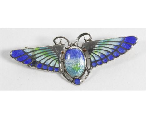 An Egyptian Revival silver and enamel scarab brooch, 1910
The winged scarab with enamel body and wings graduating from blue t