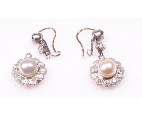 A pair of pearl and diamond ear pendants, circa 1890-1900 Each with a central pearl, approx. 6.5cm diameter, to a border of r