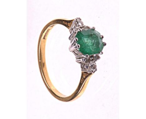 An 18ct gold emerald and diamond set dress ring
The step cut emerald of approx. 6mm x 7mm claw set to diamond set trefoil bor