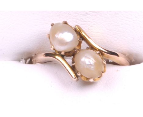 An early 20th Century 9ct gold pearl set crossover ring
The two oval blister pearls claw set to a crossover setting and plain