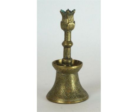 A Mamluk style incised brass candlestick, 19th/20th Century 
The bell shaped base extending to a flared dish mouth rim, the c