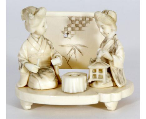 A Japanese carved ivory Okimono figure group, Late Meiji Period (1868-1912)
The sectional well carved figure group, modelled 