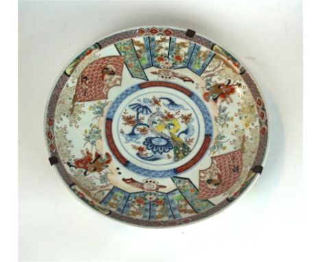 A Japanese charger, late Meiji/Taisho Period
Of circular form, the shallow well painted in underglazed blue and overglazed co