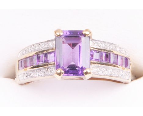 An amethyst and diamond set dress ring
The step cut amethyst of approx. 8x5mm, four claw set to diamond and amethyst set tape