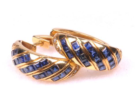 A pair of good quality sapphire and diamond set hoop earrings
Set with diagonal channels of step cut sapphires to diamond hig