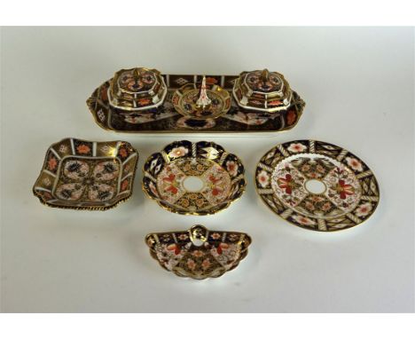 A Royal Crown Derby four piece dressing table set
Pattern no.1128, comprising two lidded trinket pots, ring tray and rectangu