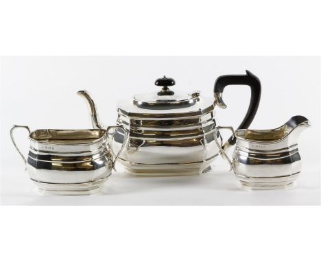 A George V hallmarked silver three piece tea service
Of plain rectangular form, made by Robert Chandler, Birmingham 1924, tot