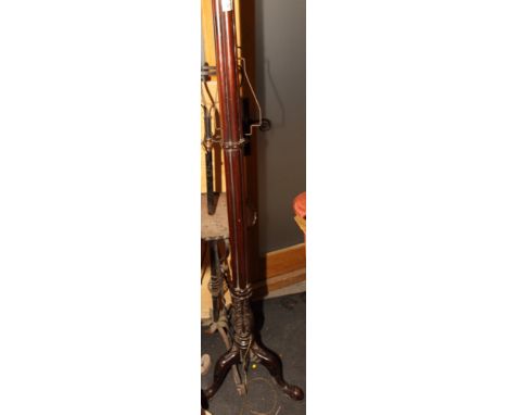 A mahogany standard lamp with carved cluster column stem, on leaf carved tripod base