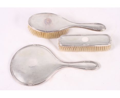 A three-piece brush set with engine turned silver backs