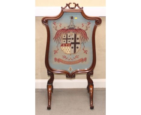 A Victorian rosewood framed firescreen carved scrolls, inset tapestry panel worked arms of the Clayton Family and motto "Virt