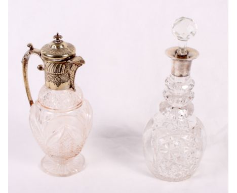 A crystal decanter with silver top, a claret jug with plated top (damage) and an urn-shaped glass vase, 19" high