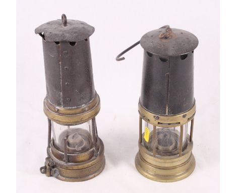 A miner's brass and steel safety lamp by Thomas & Williams Aberdare and a similar safety lamp